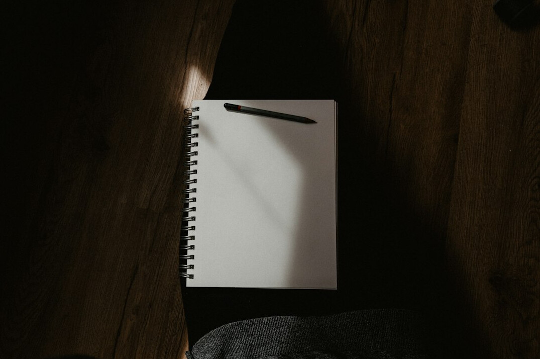 person writing in notebook